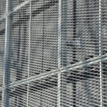 Industrial CMBS deals on track for a record year ย Closeup of wire mesh netting outside building.