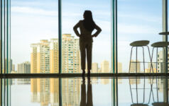 2023 review: Windows of promise in private real estate lending Woman standing in a window