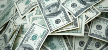 Image of piles of dollar bills.