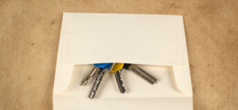 A set of keys being sent back in an envelope.