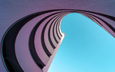 Low angle view of modern building against clear blue sky, Berlin Kreuzberg