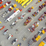 Blue Owl funds $150m loan to back Alterra IOS acquisition venture Plastic and metal ware for construction viewed from above at a depot. Industrial outdoor storage.
