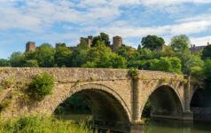 Dinham bridge over the River Teme with Ludlow castle behind in the town of Ludlow, Shropshire UK in Landscape orientation