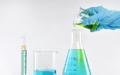 Chemist formulating solution substances, Scientist with equipment and science experiments, Laboratory glassware containing chemical liquid.