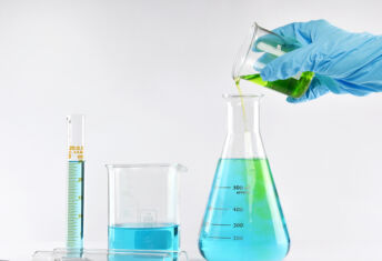 CalSTRS’ current real estate refocus is demonstrably including more credit Chemist formulating solution substances, Scientist with equipment and science experiments, Laboratory glassware containing chemical liquid.