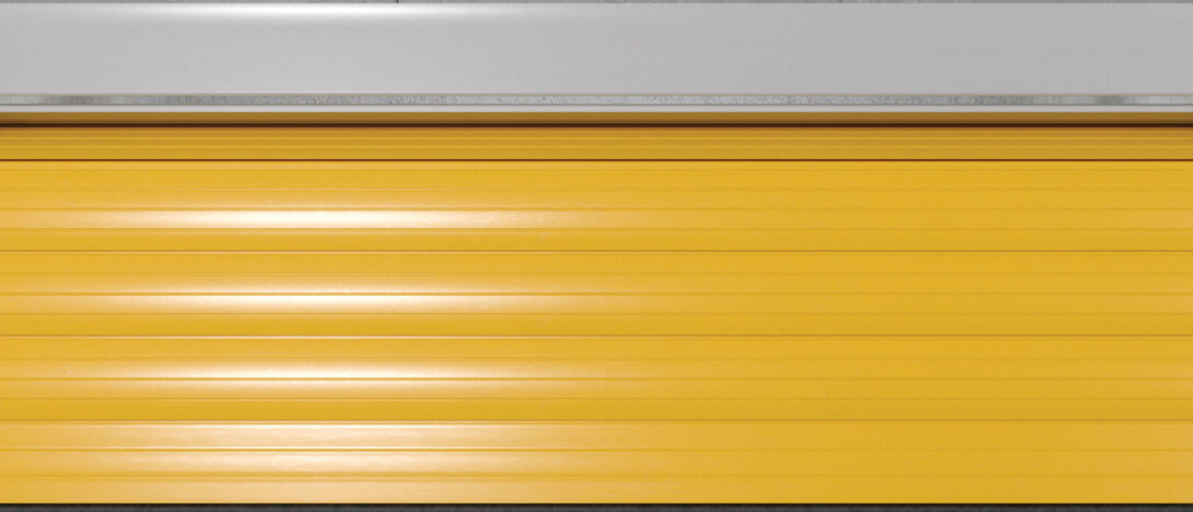 Front View Of Self Storage Units With Roller Doors. Empty Open Unit With Yellow Door Front View Of Self Storage Units With Roller Doors. Empty Open Unit With Yellow Door.