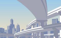 Photo of a highway overpass with a city skyline in the back.