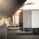 Photo of a semi-trailer truck that is ready to be loaded at a warehouse.