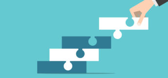 Graphic of a hand placing a puzzle piece into one piece that is connected to another piece, connecting to another.