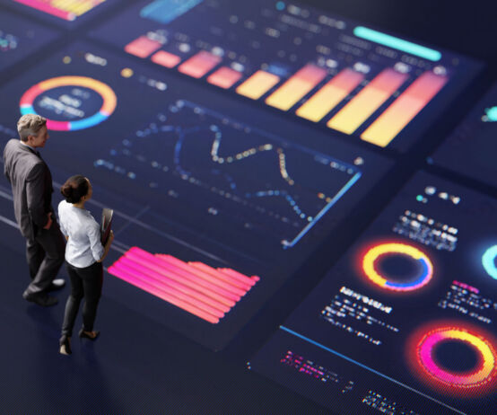 Abstract people standing on a large digital screen, analysing interactive data visualisations and charts for strategic planning. Representing teamwork, technology, and data-driven decision making in a corporate environment.