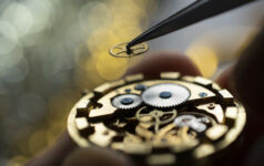 Pocket watch being repaired by senior watch maker, close-up. Black and white.