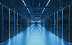 Interior view of a futuristic data center designed for artificial intelligence processing, featuring glowing servers and digital data streams.