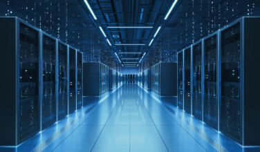 Blackstone lands a $2.05bn CMBS loan for QTS-sponsored data center portfolio Interior view of a futuristic data center designed for artificial intelligence processing, featuring glowing servers and digital data streams.