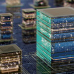 A futuristic cityscape featuring stacked glass cubes resembling data centers, reflecting lights across a circuit-like urban terrain. Symbolizes technology, innovation, and digital infrastructure powering modern cities.