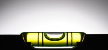 Silhouette of level against white background with copy space.