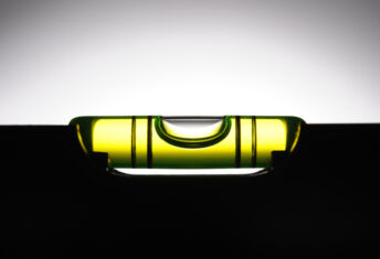 Silhouette of level against white background with copy space.