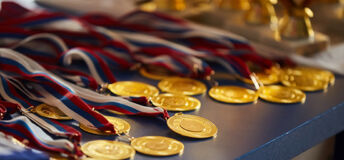 Numerous sports medals displayed on a table