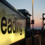 A sign that reads "Reading" on the platform at Reading Train Station