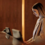 Woman working at a hotel reception desk