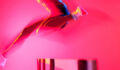 A female athlete jumps over a hurdle
