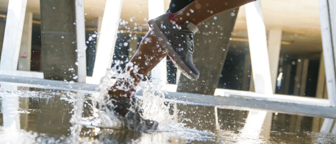 Image of feet in a puddle.