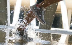 Image of feet in a puddle.
