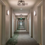 Image of a long, empty hotel hallway